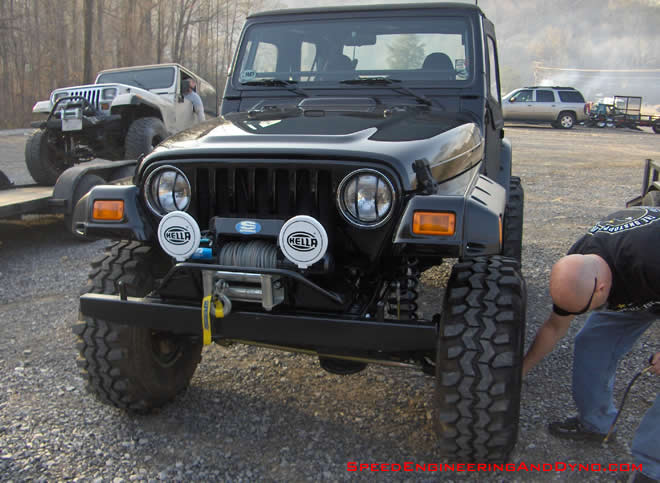 Hella lights and a superwinch and swamper TSLs help keep this 4 cylinder automatic TJ going confidently